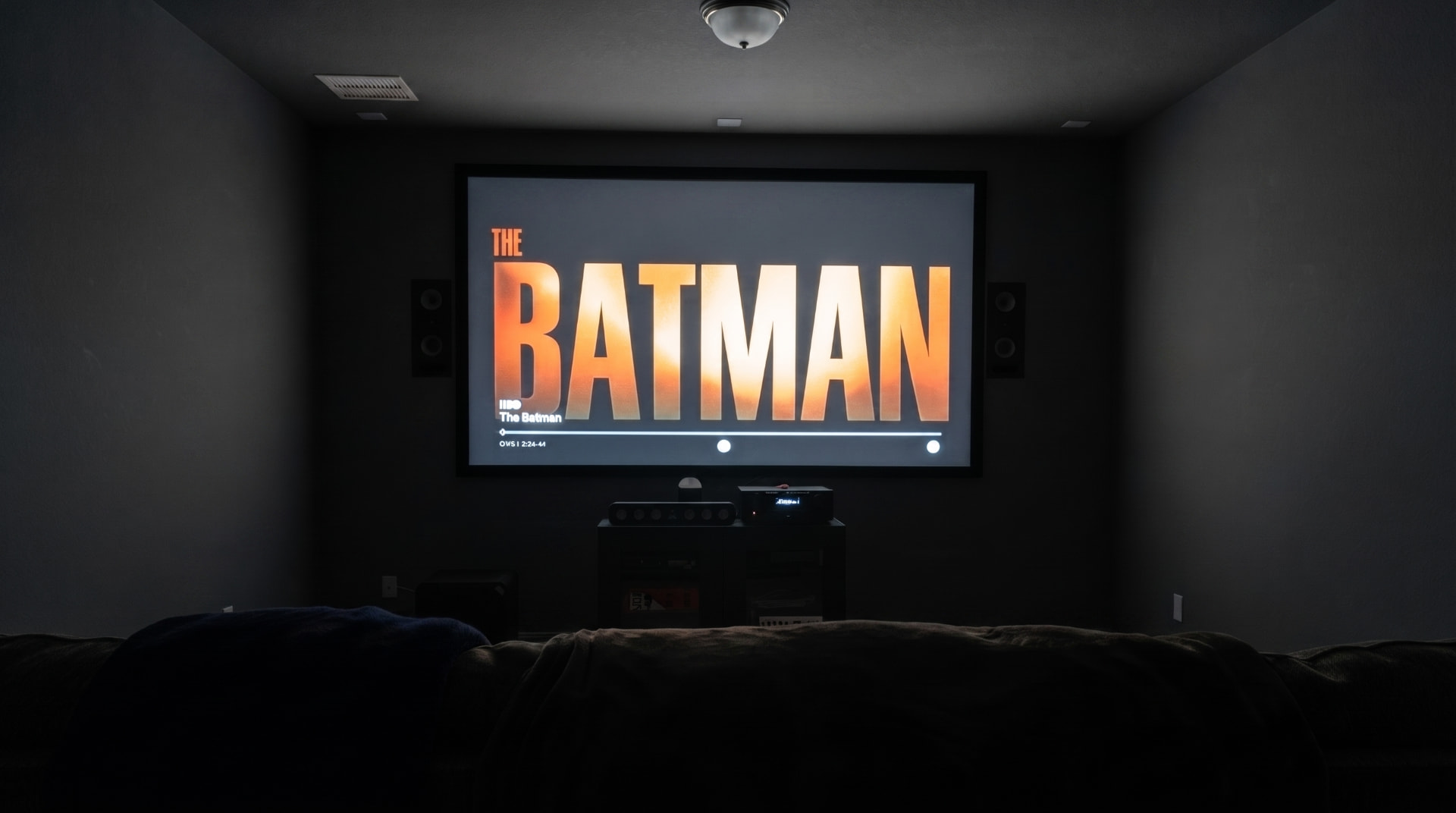 Home theater screen and speakers in a darkened Houston media room